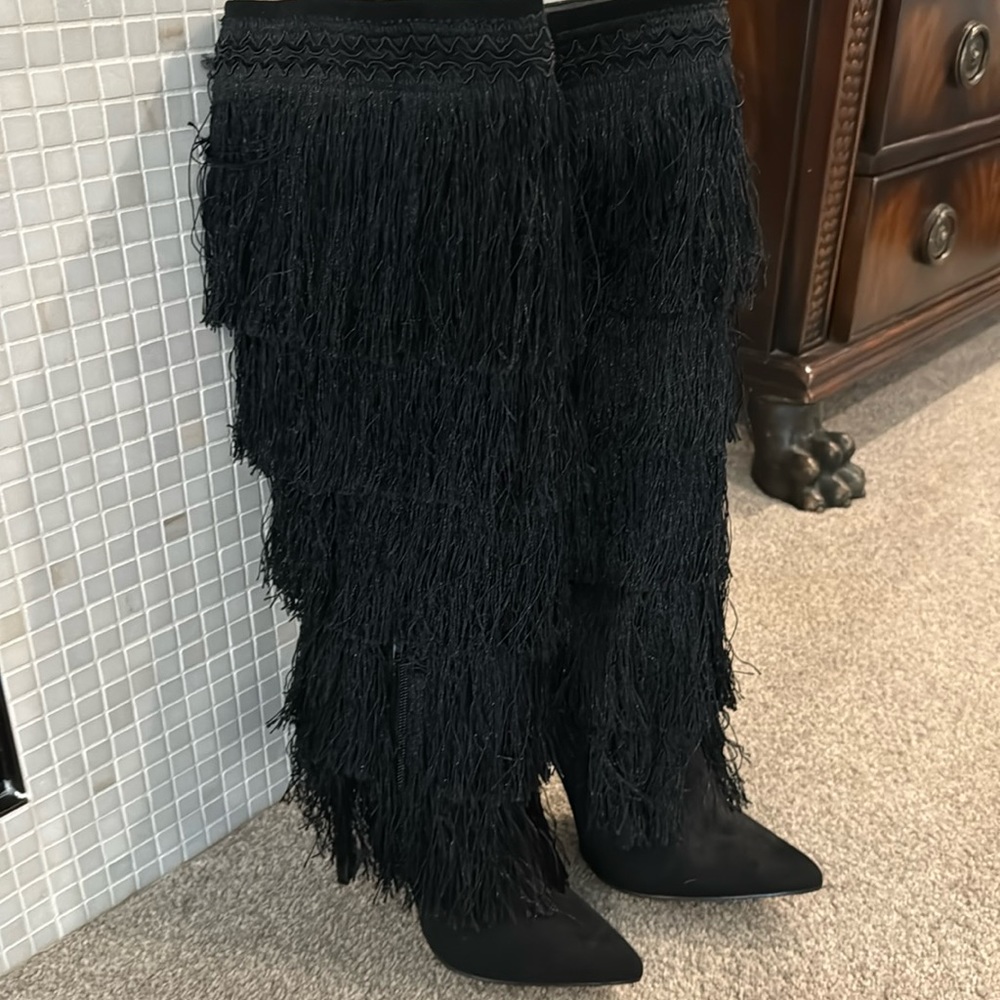 Black high heeled boots with fringe